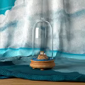 Elegant Decorative Ornament Set With Glass Dome Wooden Base And Blue White Cloudy Fabric Background