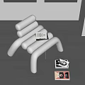 Modern Silver Metal Leisure Chair With Unique Tubular Design On Dark Wooden Floor And Books