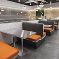 Modern Restaurant Interior With Red Brick Walls Black Orange Booth Seats And Metal Tables Chairs