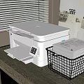 White Multifunctional Office Appliance Printer on Desk with Metal Basket and Documents