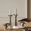 Sleek Modern Metallic Candle Holders With White Candles On Wooden Table And Minimalist Wall