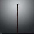 Ornate Red Staff Weapon With Golden Decorative Top And Polished Shaft