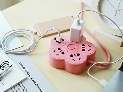 Pink Flower Shaped Power Strip with Plugs Mobile Phone and Cables on Desk 3d model