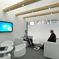 USHIO Exhibition Booth With Green Canopy Wooden Structure And Display Screens