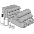Gray Towels Stacked And Rolled With Soap Dispenser Tumbler And Soap Dish In Bathroom Setup