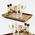 Modern Glass Cups on Wooden Tray with Glass Bottles and Green Accents