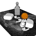 Stylish Silver Earbuds with Charging Case on Grey Tabletop and Black Bottle Orange Fruit