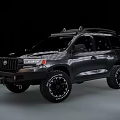 Dark Colored SUV With Off Road Tires Roof Rack And Rugged Exterior Design