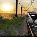 High-Speed Train Traveling On Railway Track Through Green Vegetation Misty Sunrise With Power Lines