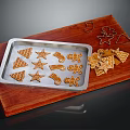 Freshly Baked Gingerbread Cookies on Baking Tray with Wooden Cutting Board and Star Shapes