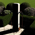 Outdoor Electric Vehicle Charging Station With Green Lawn And Flower Beds