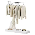 Hanging Beige Clothes With Matching Bag Shoes And Accessories On White Table