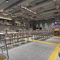 Modern Restaurant Interior With Exposed Ceiling Metal Tables Yellow Floor Lines And Green Plants