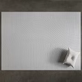 Modern White Square Rug With Wavy Lines Pattern And Small Pillow On Gray Floor