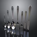 Silver Cutlery With Spoons Forks Knives Neatly Arranged In Various Sizes On Dark Reflective Surface