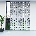 White Geometric Room Divider With Hollow Patterns In Modern Interior With Green Plants And Window