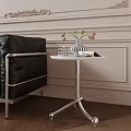 Modern Side Table with Black Chair Vase Flowers on Light Colored Wall Wooden Floor