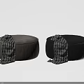 Two Stylish Black and Taupe Ottomans with Plaid Blankets Draped Over