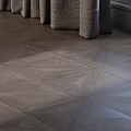 Gray Wooden Floor With Intricate Geometric Patterns And Woven Stool Legs Design