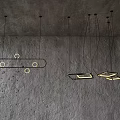 Modern Geometric Pendant Lights With Metal Frames And Warm Glow On Gray Ceiling