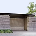 Modern Entrance Gate with Brick Wall and Lush Shrubs Along Illuminated Driveway