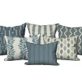 Various Blue And White Decorative Pillows Featuring Leaf And Geometric Patterns