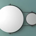 Large and Small Circular Mirrors With Black Metal Frame Mounted on Light Green Wall