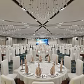 Elegant Banquet Hall With Round Tables White Chairs Table Settings And Chandeliers