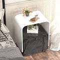 White and Black Modern Nightstand With Flower Vase Cookies Candle and Book