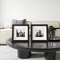 Black Picture Frames With Architectural Photos On Round Coffee Table In Living Room
