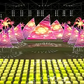 Vibrant Stage Design With Pink Triangular Structures Palm Decorations Lighting And Yellow Green Cube Seats 3d model