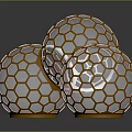 Three Honeycomb Patterned Spheres With Golden Frames And Transparent Interior On Reflective Surface