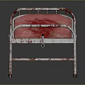 Old Medical Equipment Hospital Bed With Metal Frame And Red Stained Mattress