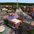 Fun Filled Amusement Park With Various Rides Colorful Pavilions And Lush Green Gardens
