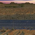 Desert Landscape With Railway Tracks Sparse Vegetation Under Sunset Sky And Distant Hills