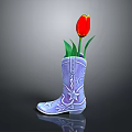 Blue Cowboy Boots with Star and Pattern Decorations Used as Flower Vase Holding Red Tulip