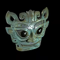 Ancient Bronze Mask With Large Eyes And Intricate Mythical Carvings