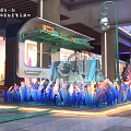 Decorative Teal Tram In Indoor Mall With Columns And Pedestrians Around