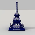 Kinderburg Themed Eiffel Tower Model With Small Figures On Tower Structure Standing On Blue Base