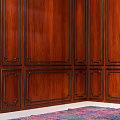 Elegant Green Velvet Single Sofa in Room with Wooden Paneled Walls and Colorful Rug