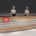 Modern Wooden Striped Reception Desk With The Solar Revolution Logo And Two Receptionists Behind