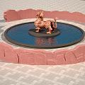 Red Rock Feature Wall With Round Water Pool And Dragon Statue On Gray Brick Pavement