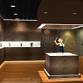 Cultural Center Showcasing Traditional Statues in Glass Cases with Decorative Walls and Wooden Floors