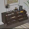 Wooden Dresser with Golden Handles Featuring Lamp Books and Green Plant on Top