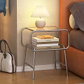 Modern Metal Frame Bedside Table With Table Lamp And Books Near Leather Headboard