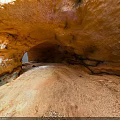 Red Rock Cave Interior With Natural Arch Gravel Floor And Entrance Light