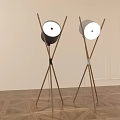 Two Modern Floor Lamps With Wooden Cross Legs And Round White Shades In Interior