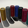 Vibrant Cylindrical Speakers with Multiple Colors Arranged in Arc and Brand Logo