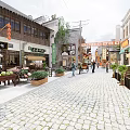 Traditional Chinese Commercial Street With Cobblestone Pavement Shop Signs And Pedestrians