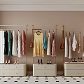 Three Golden Clothes Racks with Hanging Colorful Clothes Handbags Below Drawer Cabinets and High Heels